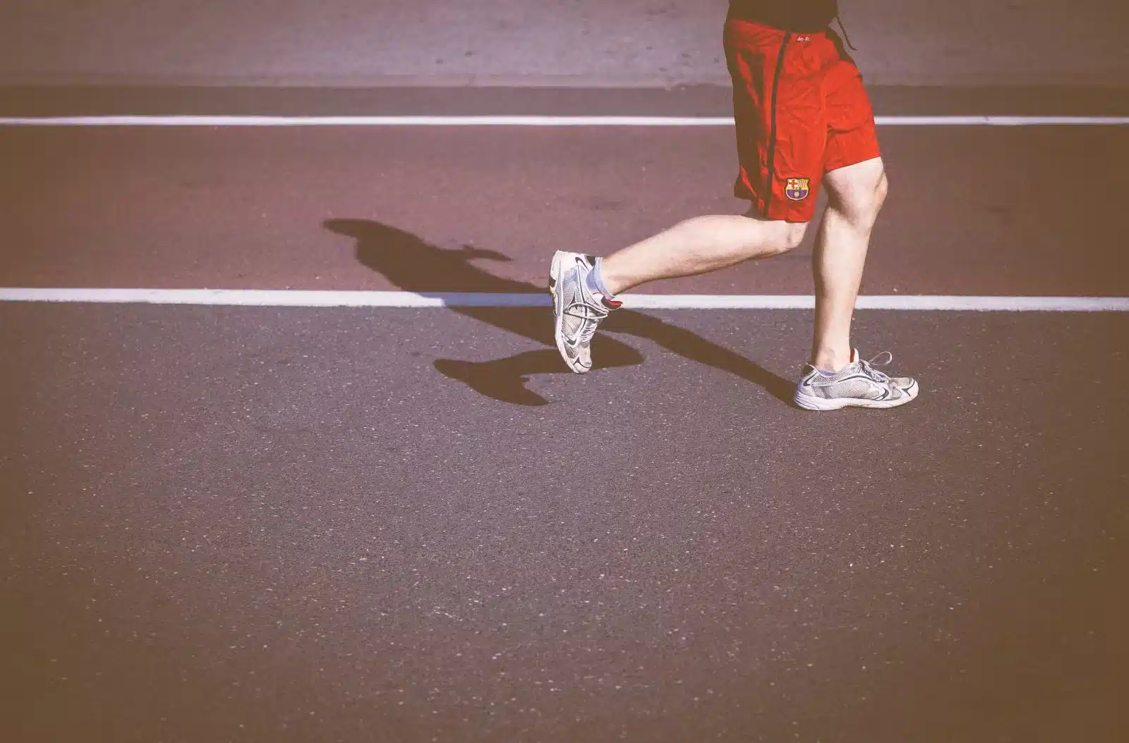 man running and wearing red shorts